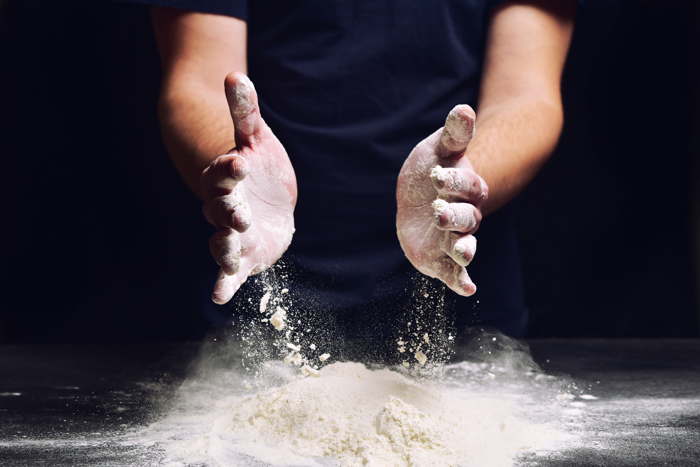 Hand of chef with flour close up. Homemade culinary traditional prepare.